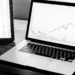 Algorithmic trading platform displayed on a laptop with charts and market data.