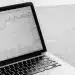 Betterment High-Yield vs. FN Capital investment analysis on laptop.