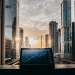 Algorithmic trading platform on tablet with city backdrop.