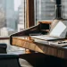 Financial planning tools for six-figure earners on a desk with a city view.
