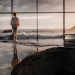 Laptop on rock by ocean view. Smart investing for early retirement.